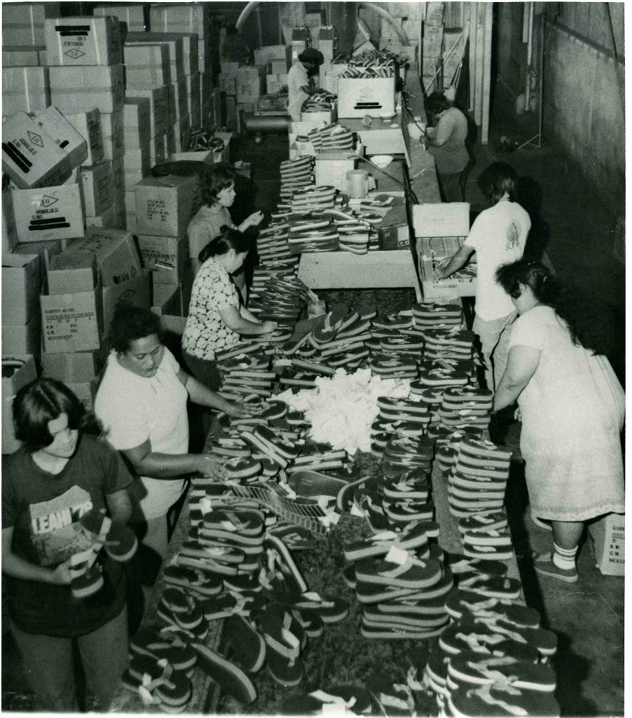 Workers in the warehouse packing slippers.